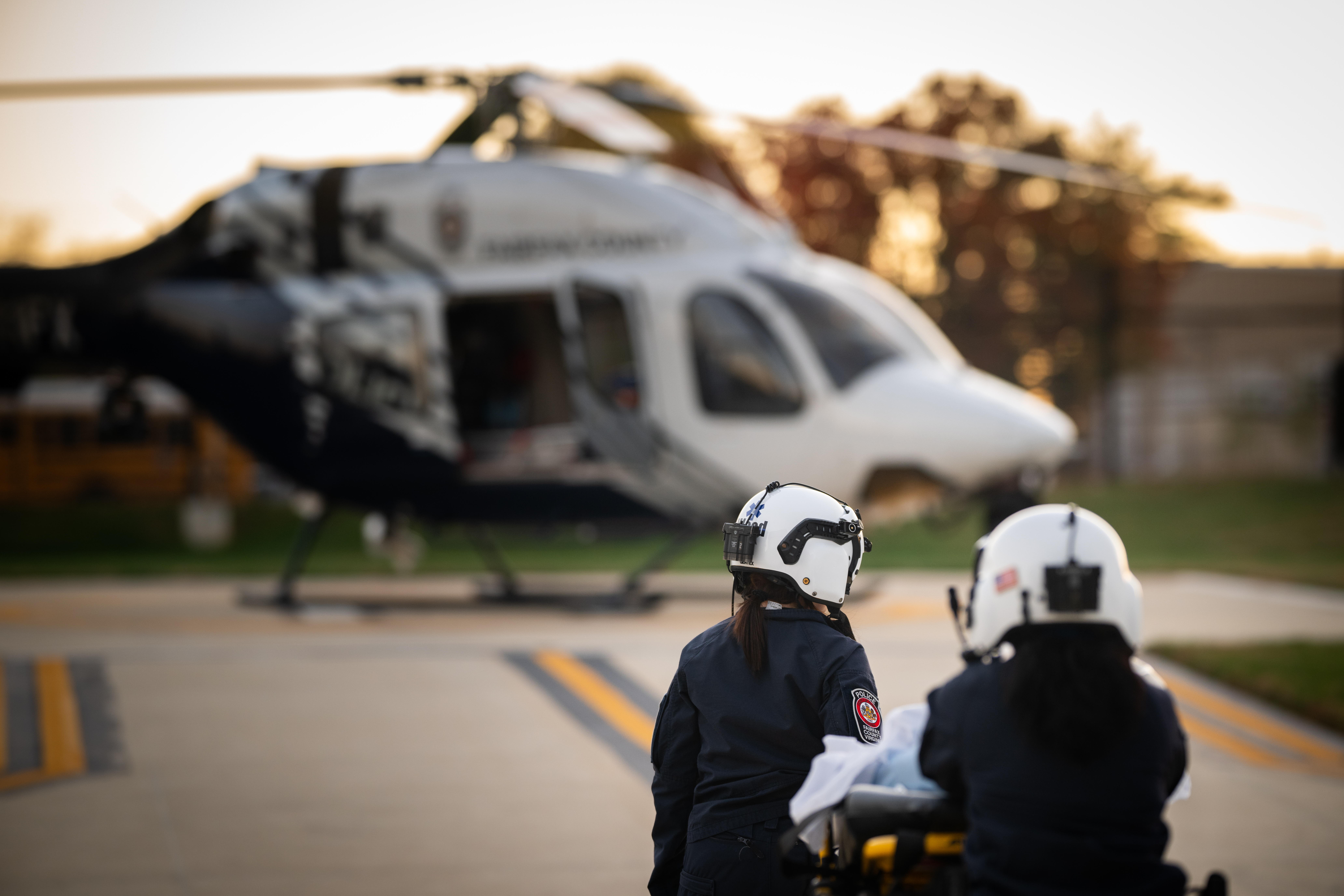 two officers running a medical evacuation towards the fairfax helicopter