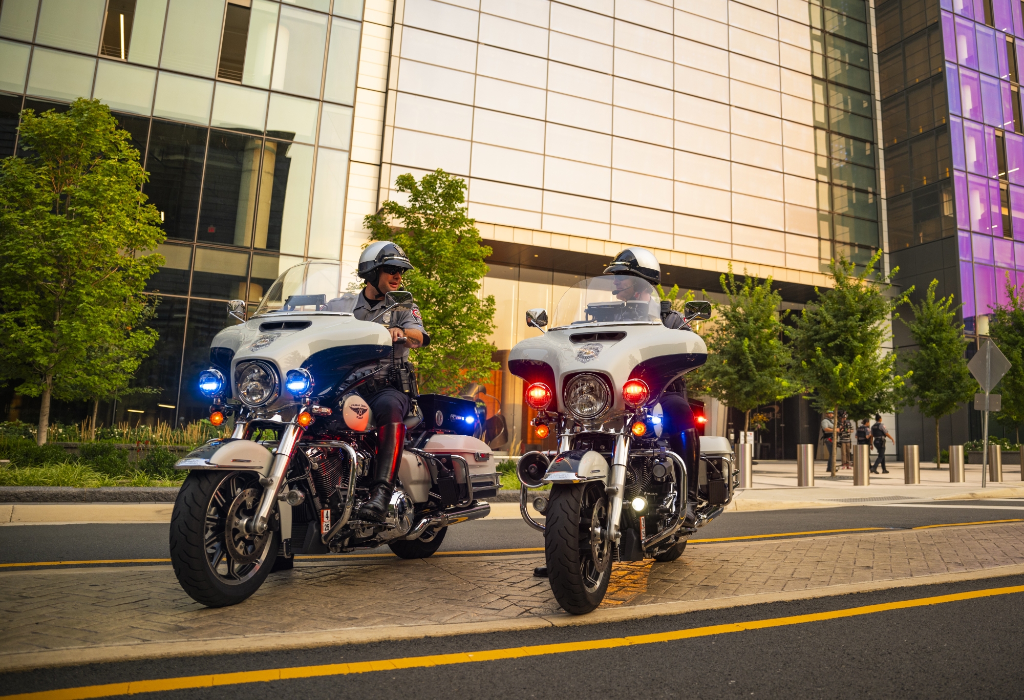 Two FCPD motorcycle officers stopped on Harley-Davidson police motorcycles at a city intersection