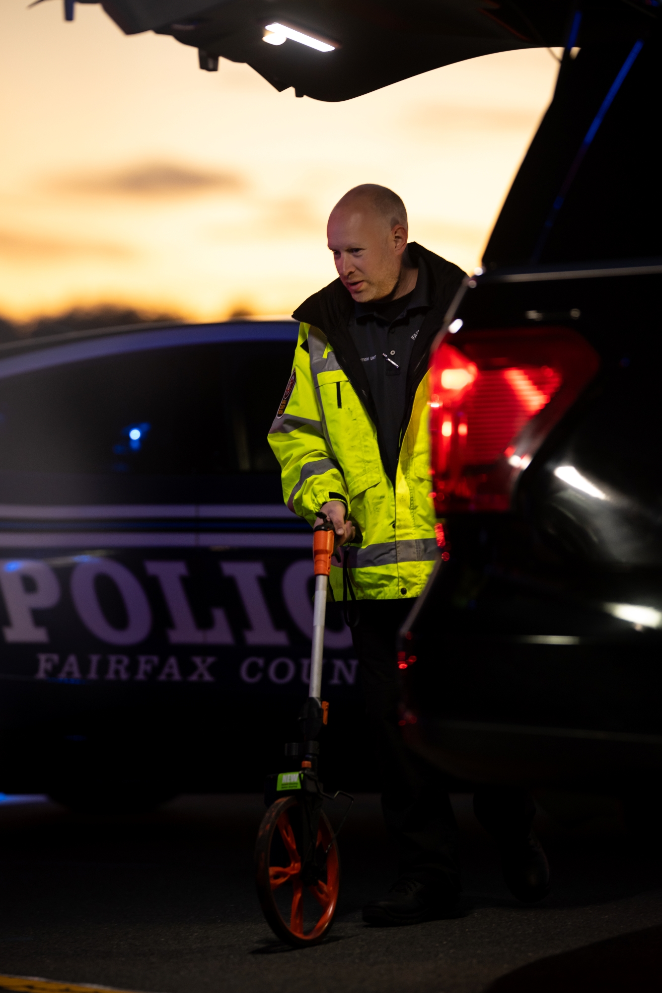officer on site with a measurement tool