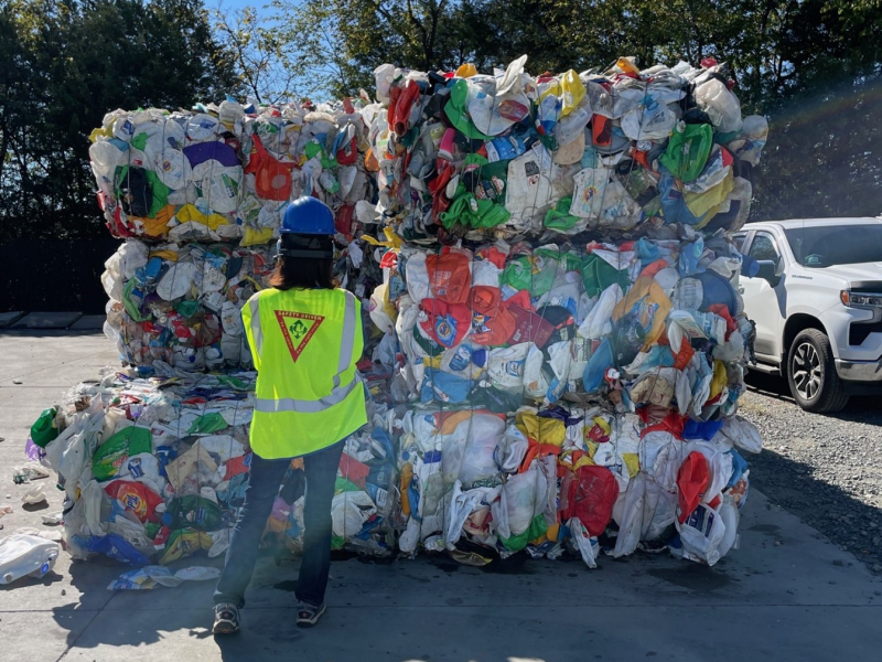 Staff in front of trash pile