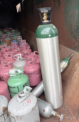 Compressed air tanks among recycled metal pile
