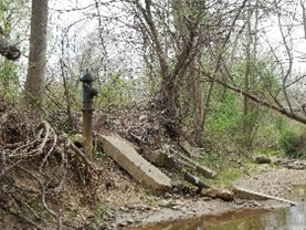 Photo: Eroding stream has exposed Fairfax Water infrastructure leaving it vulnerable to damage