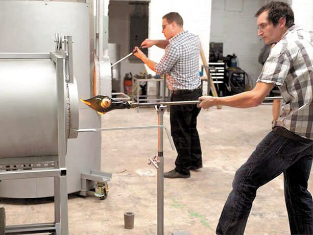Participant blowing glass.