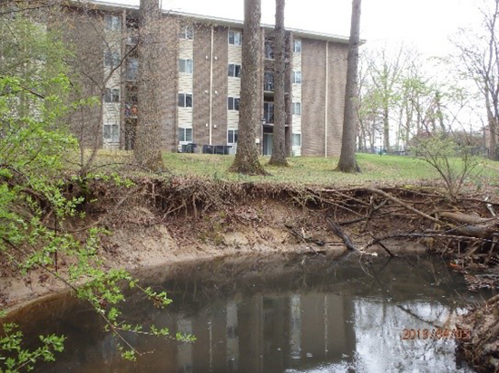 Eroded vertical banks moving toward Arrowhead Apartments