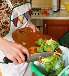 Scrape food scraps into compost bucket