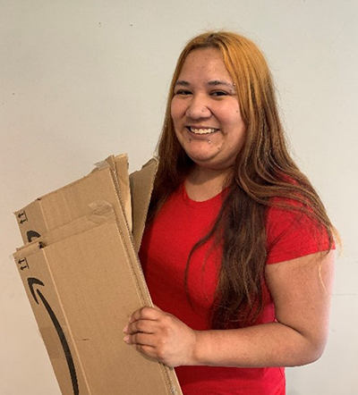a person holding cardboards