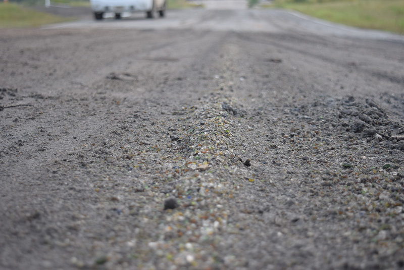 Crushed glass is visible in this repaired section of road.