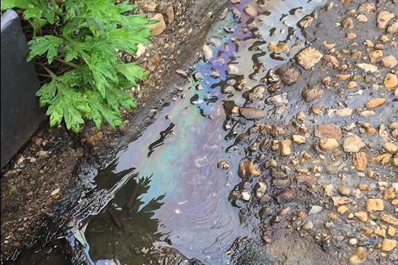 oil and water running toward storm drain
