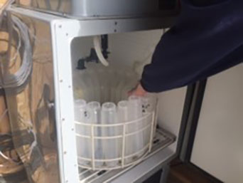 A picture of the refrigerated stream auto-sampler inside of a gage house of an intensive monitoring site.