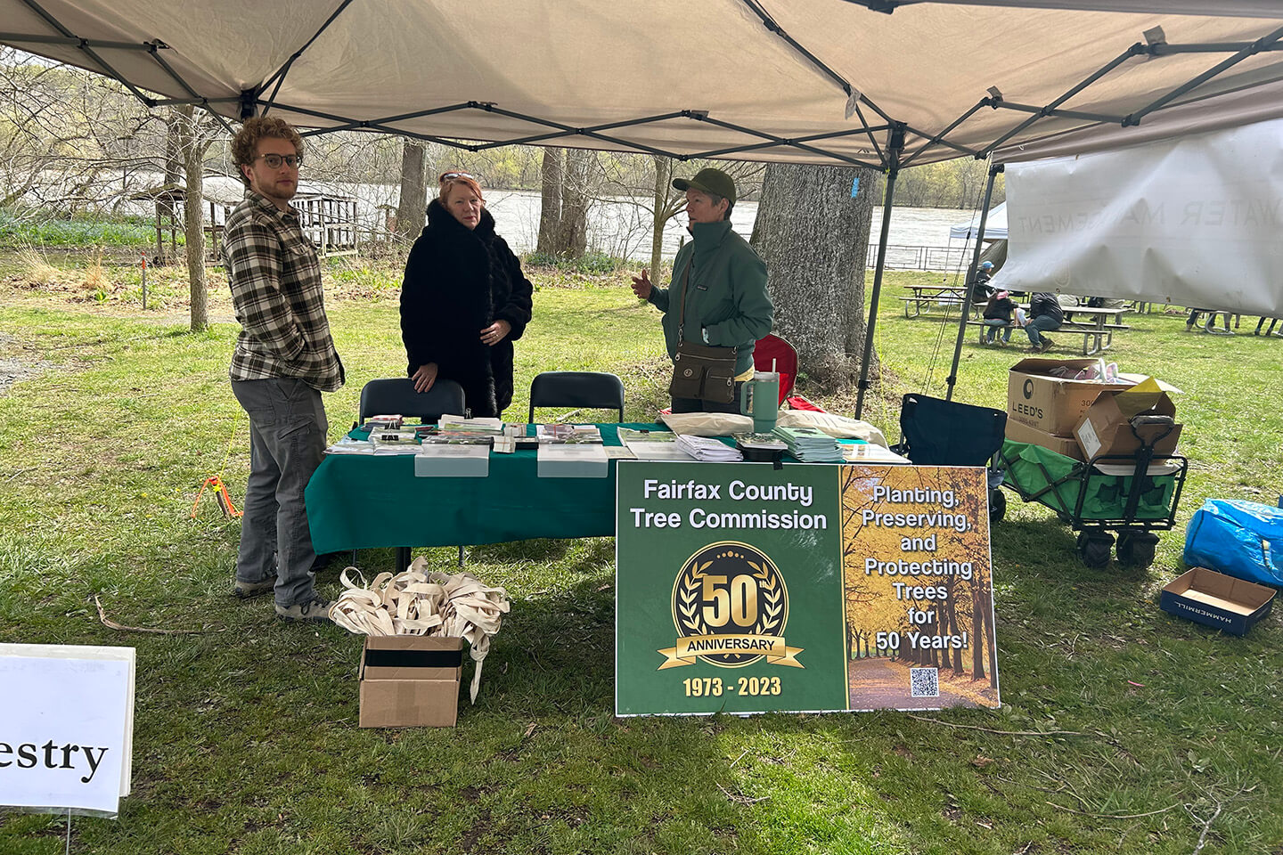 Staff at Bluebell at the Riverbend park talking to event participants. 