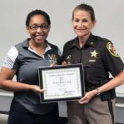 Sheriff Kincaid presents Sesaly Barden with a scholarship certificate