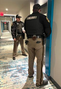2 deputies at a door ready to serve civil documents 