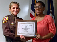 Sheriff Kincaid presents scholarship certificate to Sesaly Barden.