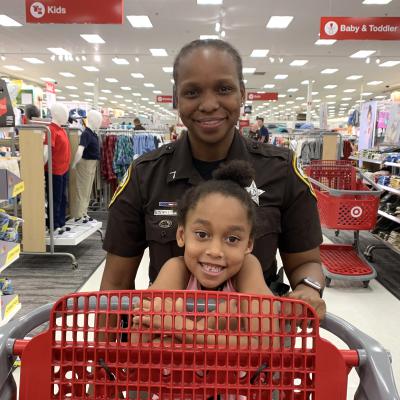 Deputy and girl pushing cart at Target