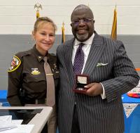 Sheriff Kincaid presents Pastor Walton with challenge coin