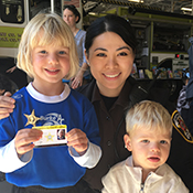 Deputy with children holding ID cards