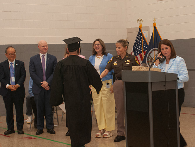 Sheriff Stacey Kincaid shakes the hand of one of the inmates who graduated June 12.