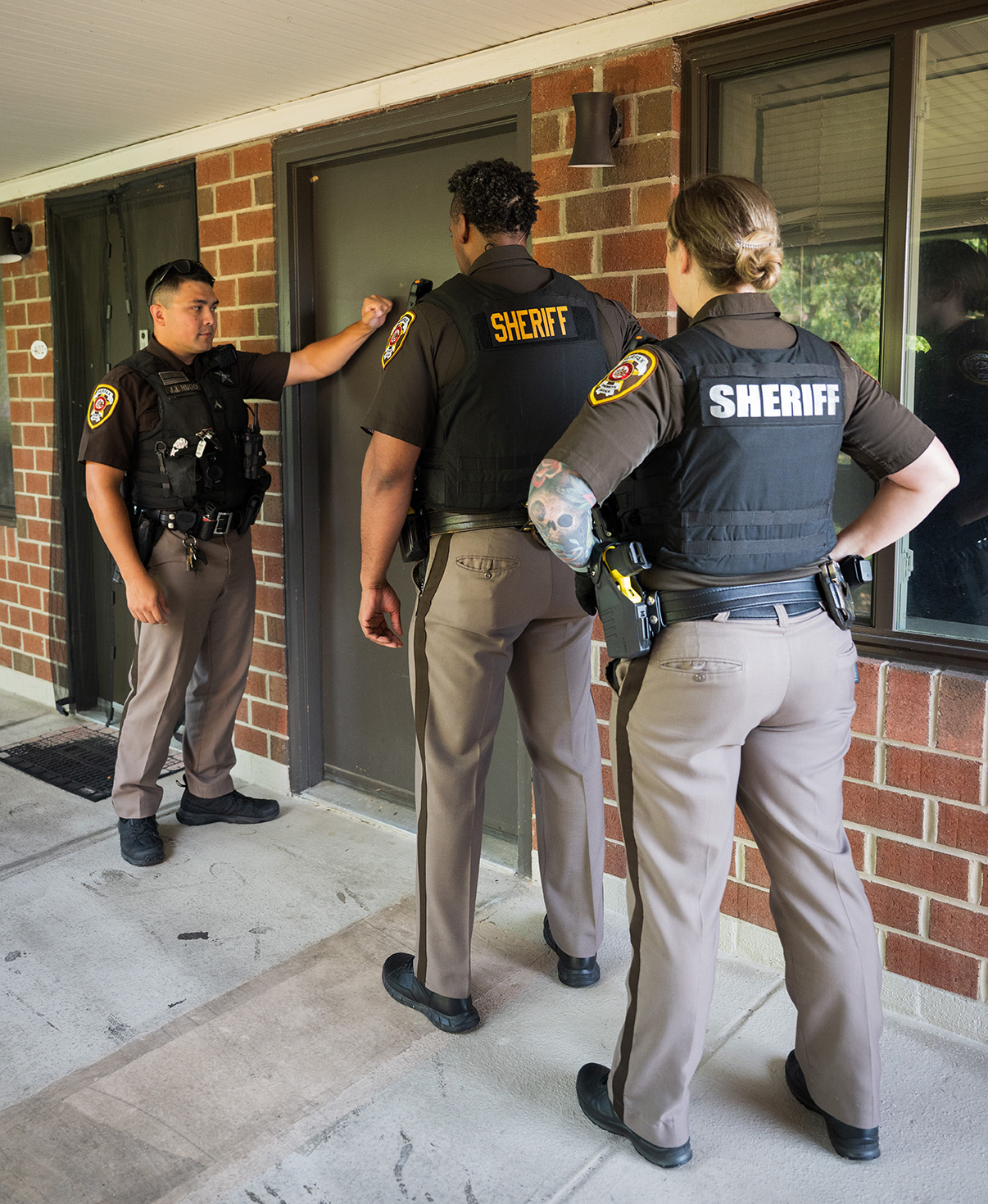 Fairfax County Sheriff's Deputies serve papers at a residence.