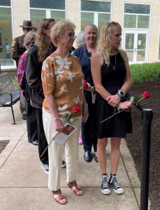 Family waits in line to lay roses at memorial