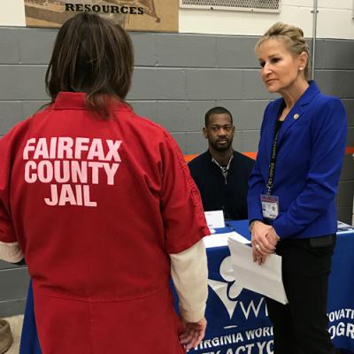 Inmate speaks with Sheriff Kincaid and vendor at resource fair.