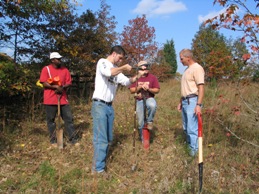 Using a soil auger to take a core sample.