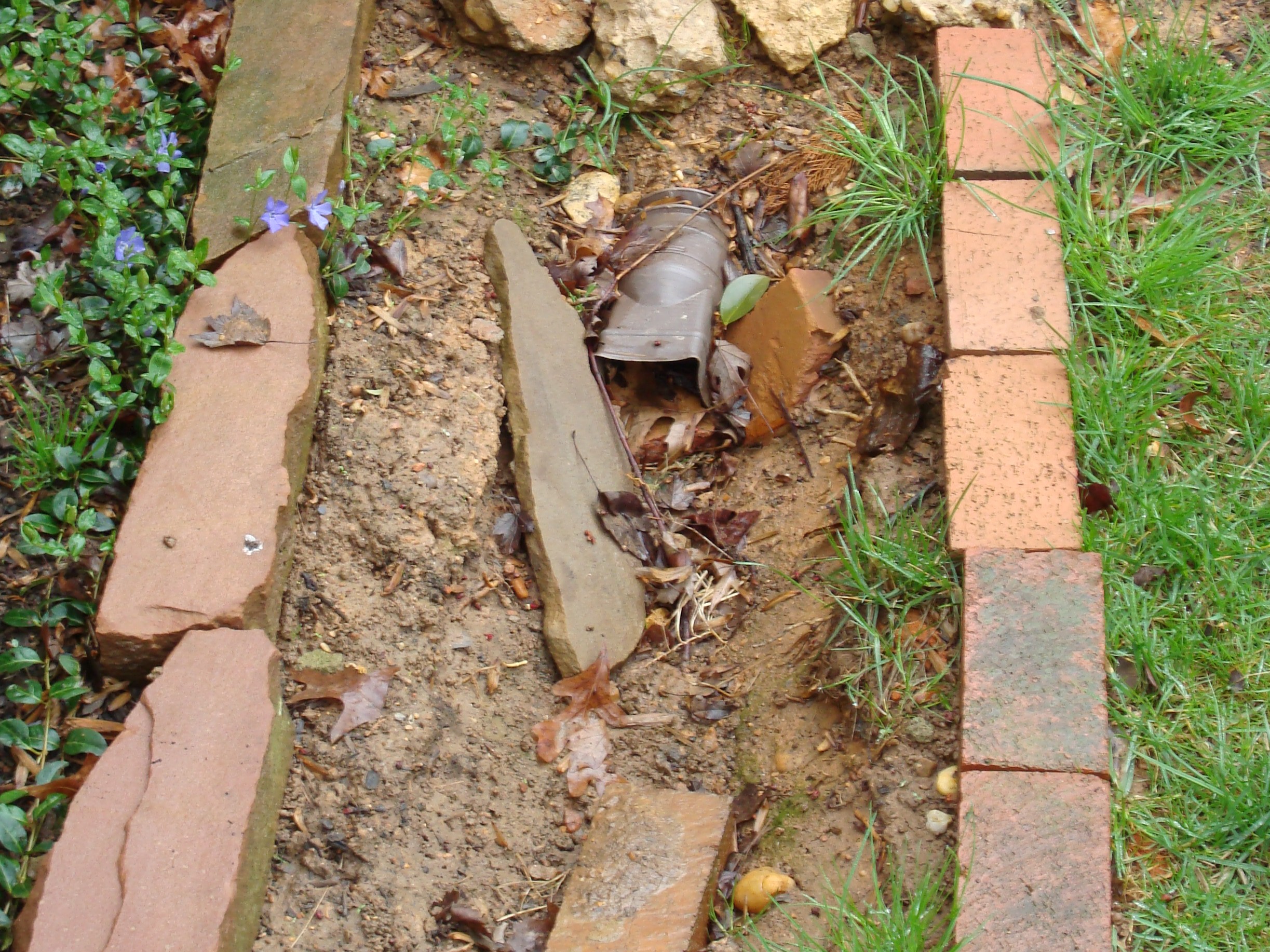 Erosion at the end of the downspout.