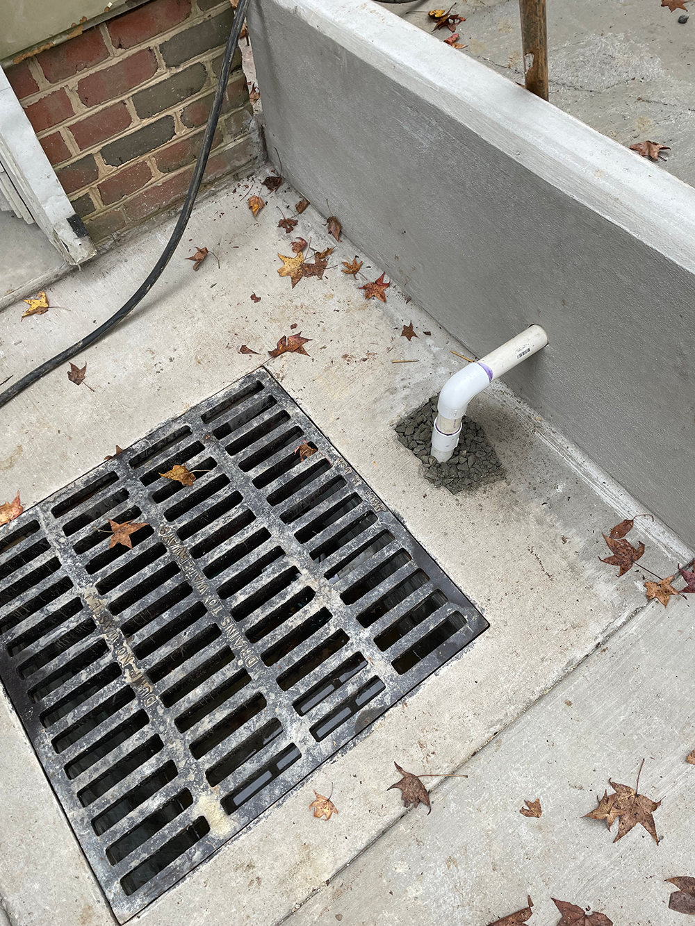 Drain at the base of external stairs