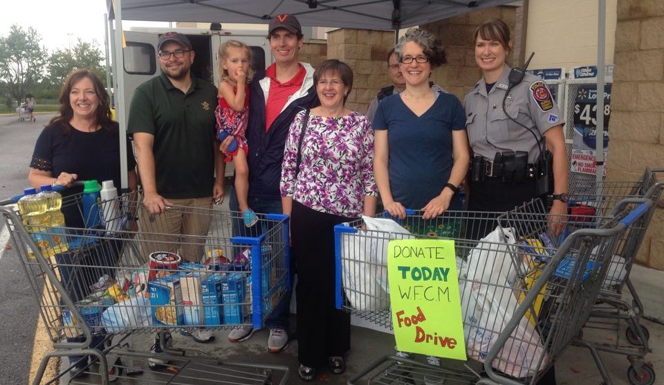 Kathy Smith with WFCM and Sully Police at Food Drive