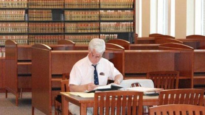 Man sitting at desk in a library