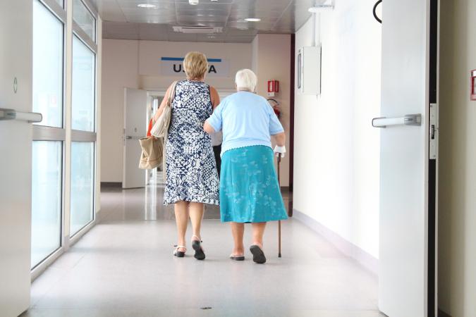 two older women walking down hallway