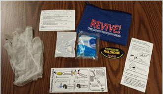 photograph of a Revive! kit featuring medication and information.