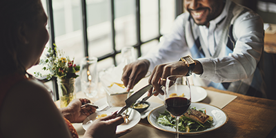 two people eating a restaurant booth